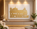 Handmade Golden Temple gold foil canvas wall art hanging above a modern sofa in a living room